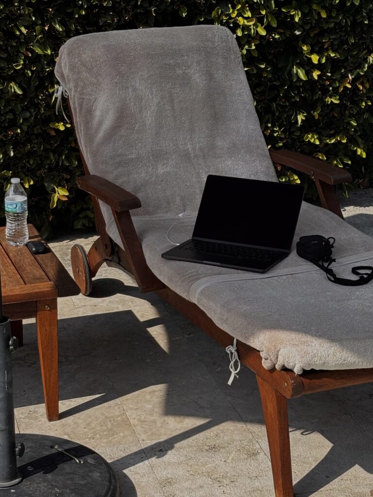 Working poolside on a laptop, planning a Pinterest strategy for growing an email list
