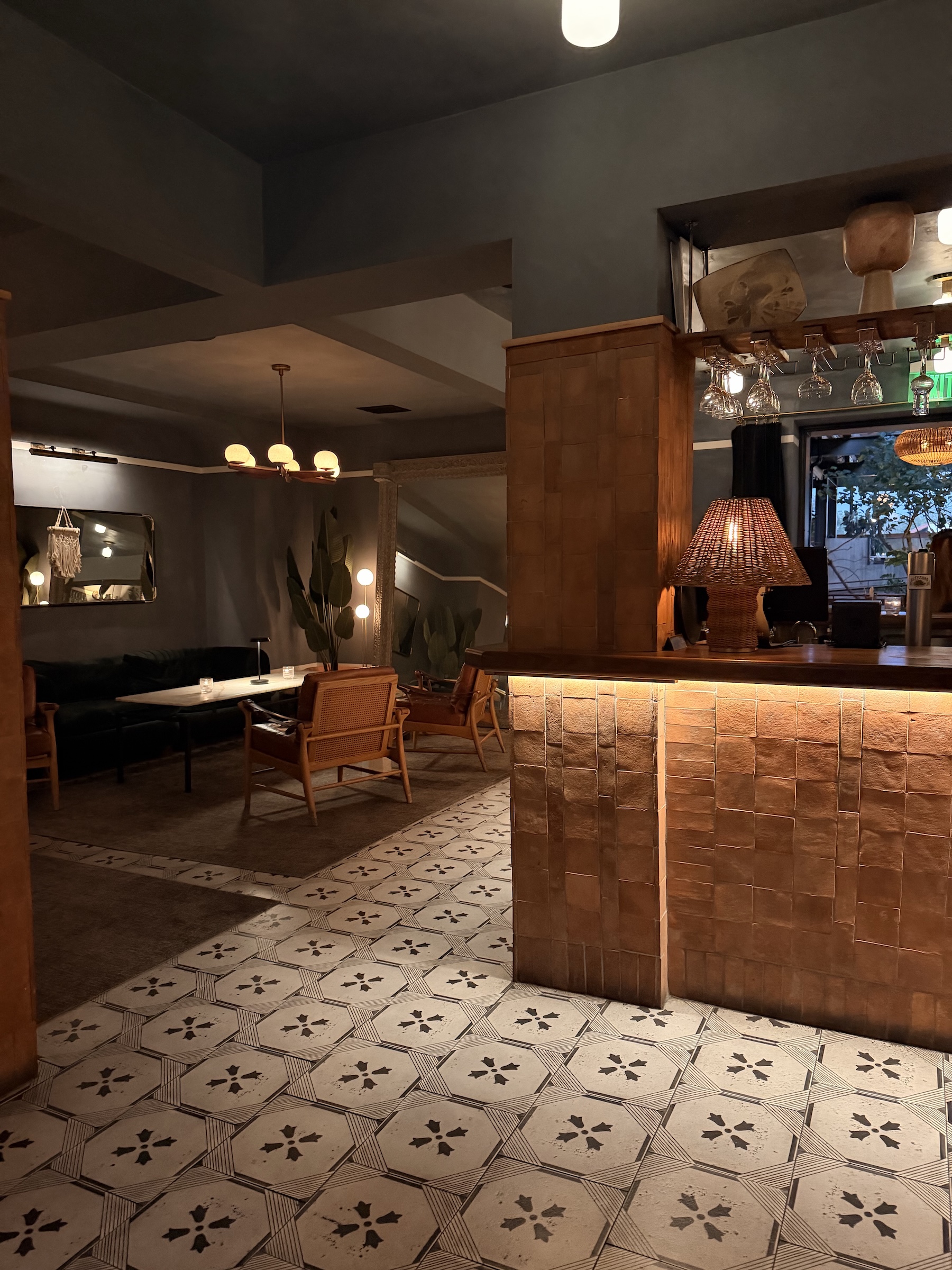 A warm, moody interior of a cafe or lounge with tiled floors and soft lighting, symbolizing the quiet patience needed to ignore Pinterest analytics and data for the first three months while the platform indexes your content.